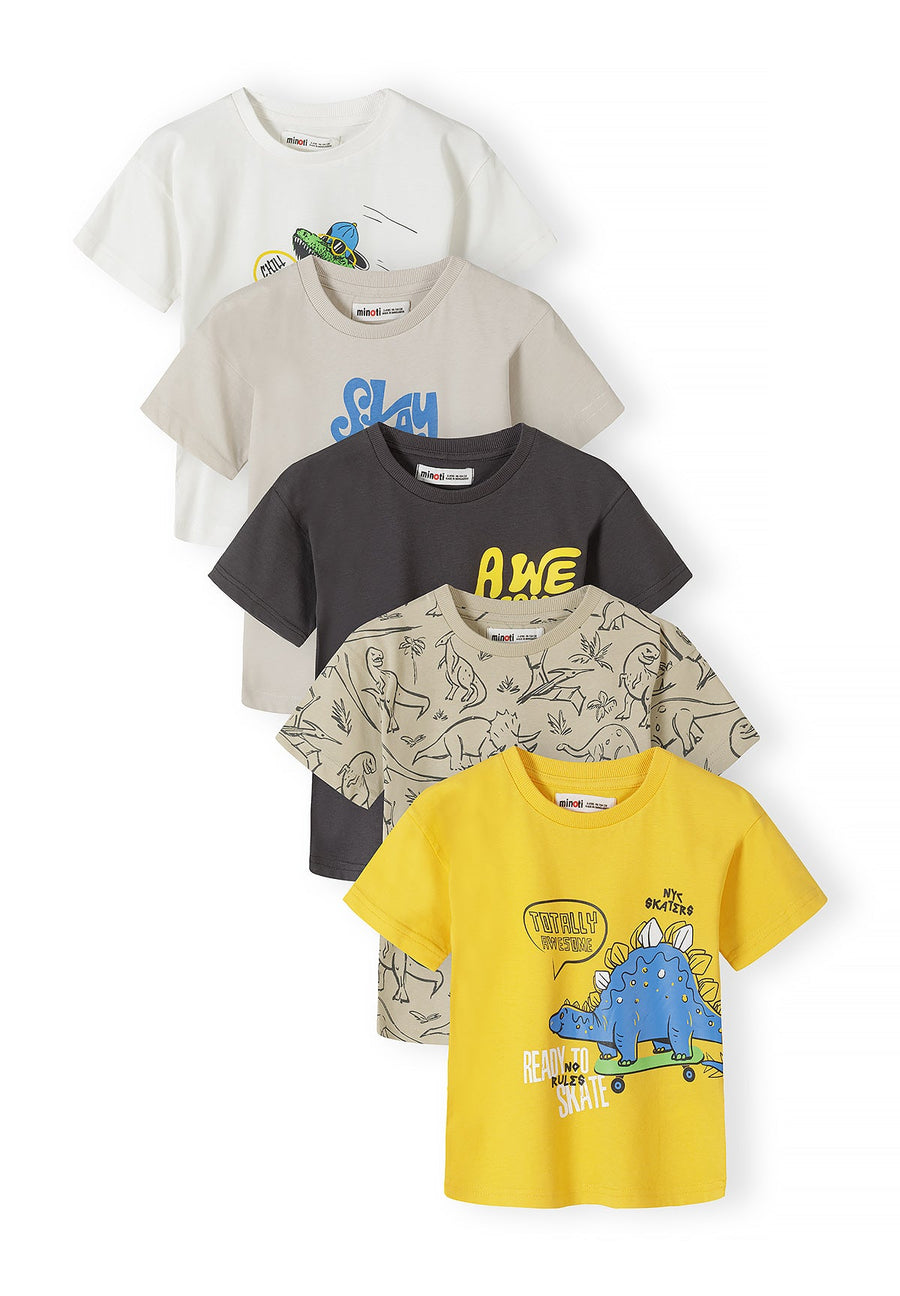 Stack of five cotton t-shirts in mixed colours showing dinosaur prints, including white, beige, yellow, charcoal and patterned designs arranged in fan layout
