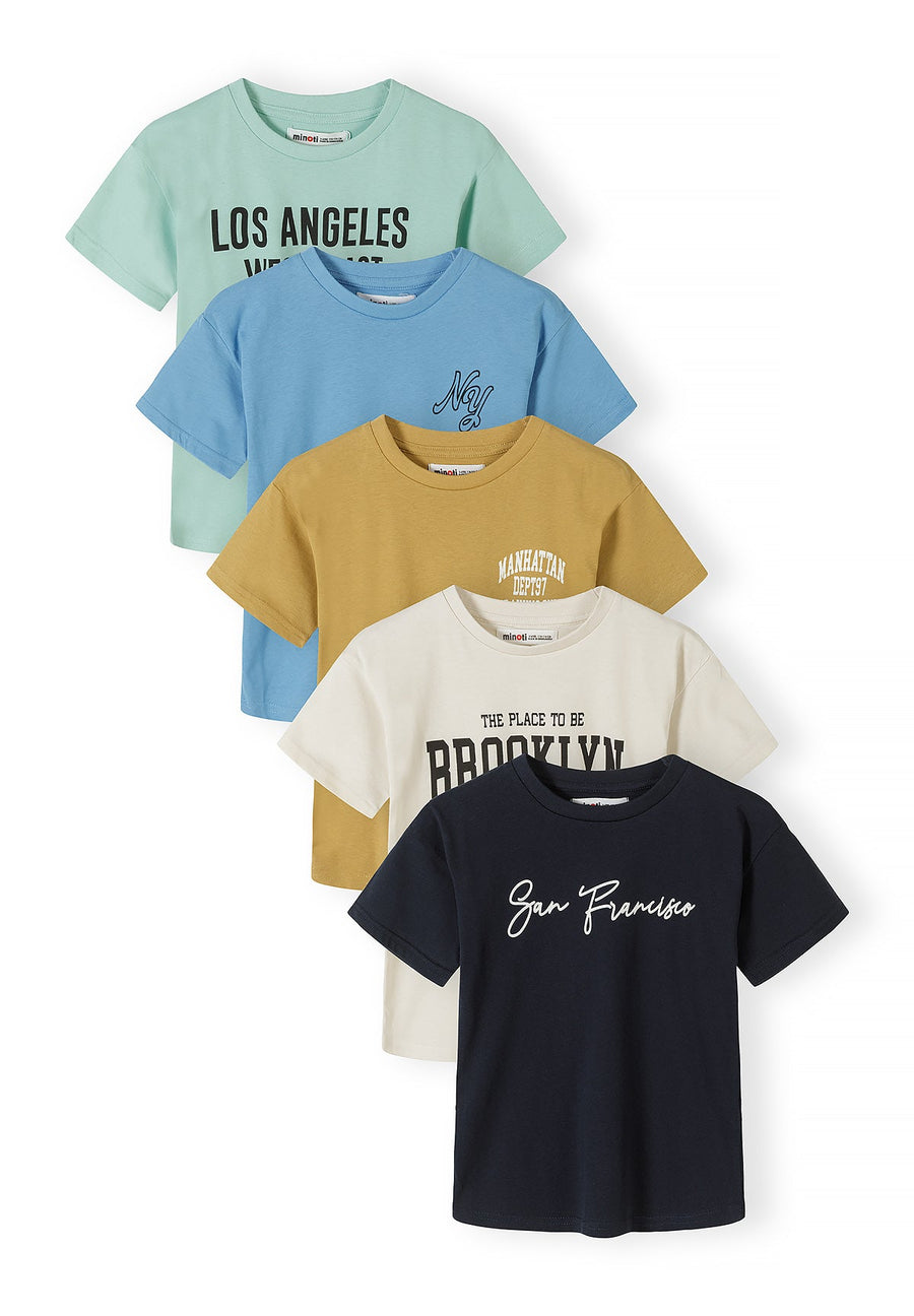 Five cotton t-shirts arranged in overlapping stack showing mint green Los Angeles print, sky blue NYC print, mustard Manhattan print, cream Brooklyn print and navy San Francisco print on white background
