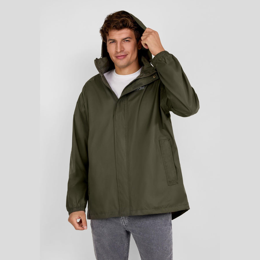 Male model wearing khaki packaway waterproof jacket with hood up, hands adjusting hood, paired with grey jeans against white background