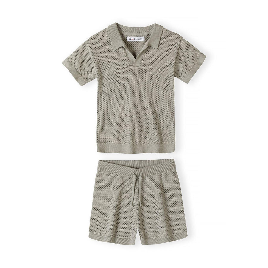 Back view of khaki knitted polo shirt showing textured mesh-like pattern and ribbed neckline on white background