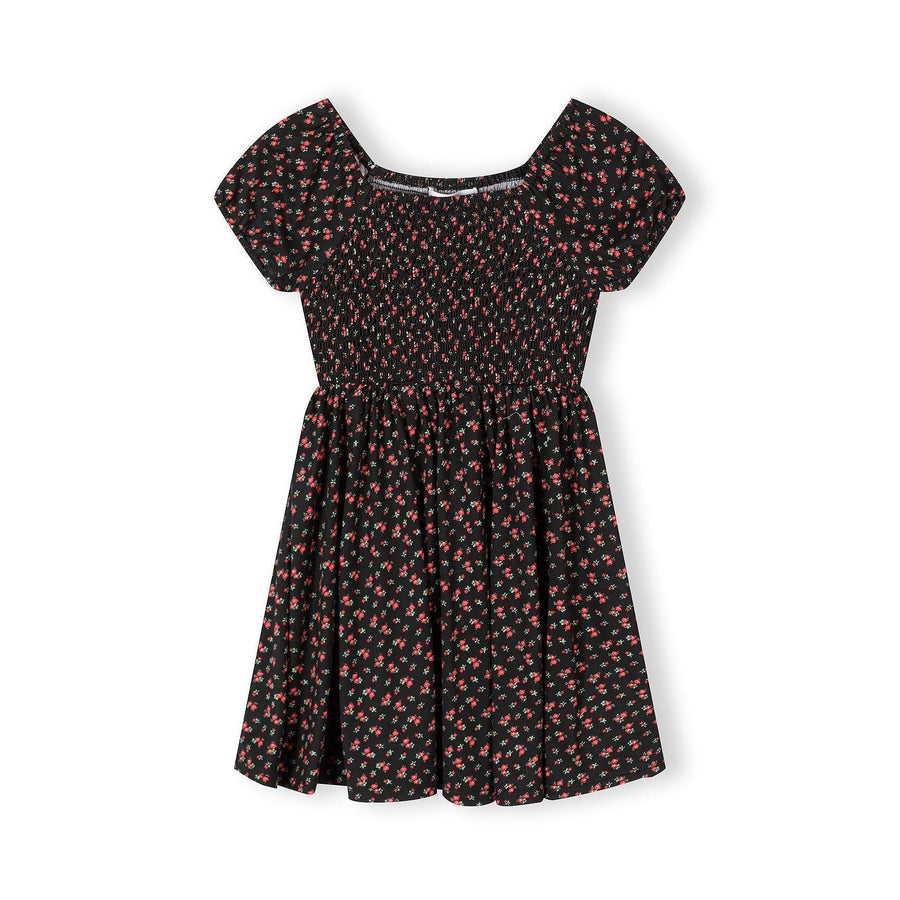 Black floral dress with short sleeves and shirred bodice featuring small red and pink flower print, displayed flat against white background