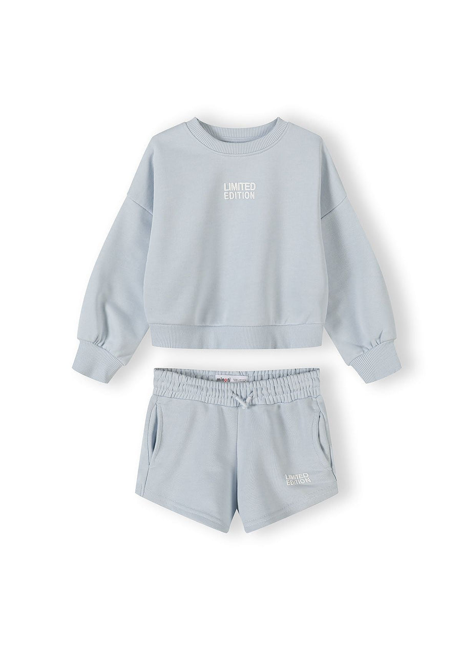 Light blue sweatshirt and shorts set laid flat on white background showing Limited Edition text on both pieces