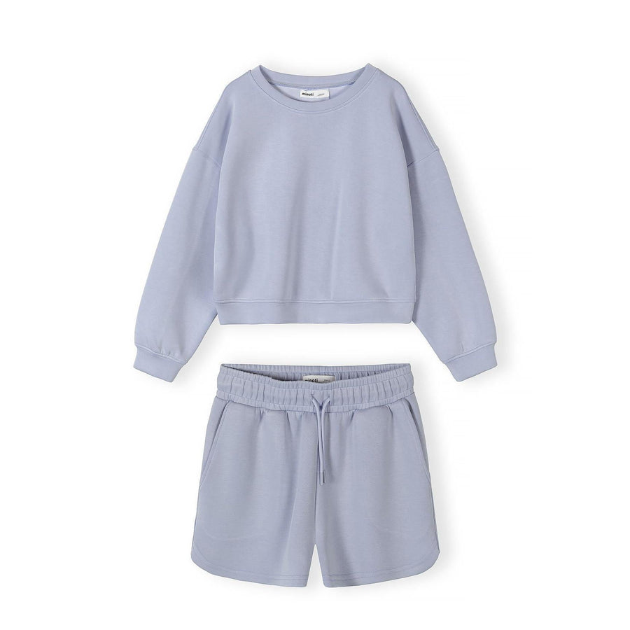 Lavender blue tracksuit set with sweatshirt and shorts displayed flat on white background