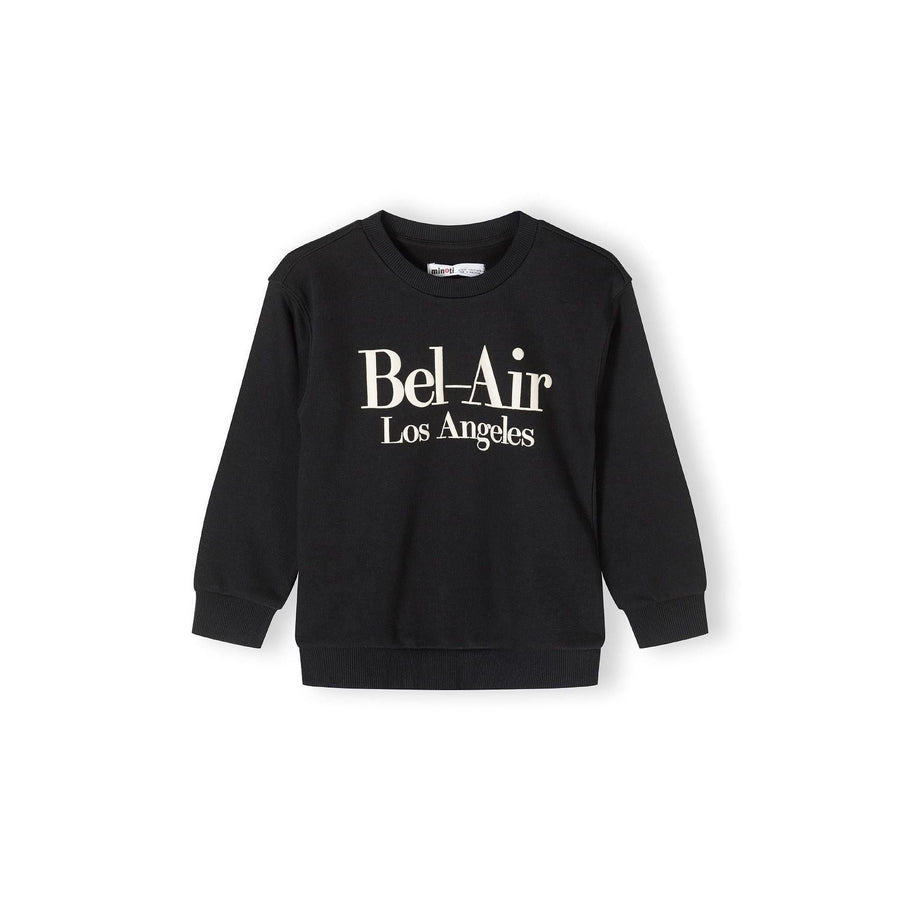 Back view of black crew neck sweatshirt laid flat showing plain design with ribbed collar, cuffs and hem against white background